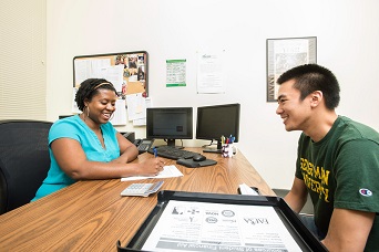 A school advisor helping a student in her office