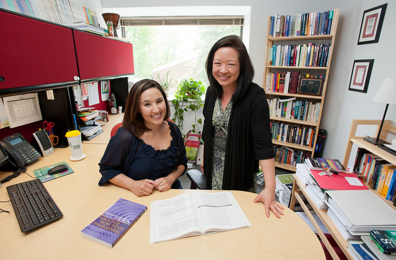 George Mason office with two advisors, one standing, one sitting.